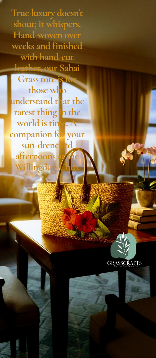 Woven straw handbag with leather flower ensembles and leather handle, with flowers on a table in a cozy room with warm lighting.