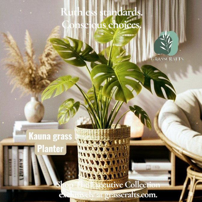Potted plant in a kauna grass planter in a decorative setting with books and a candle, featuring the Grasscrafts brand.