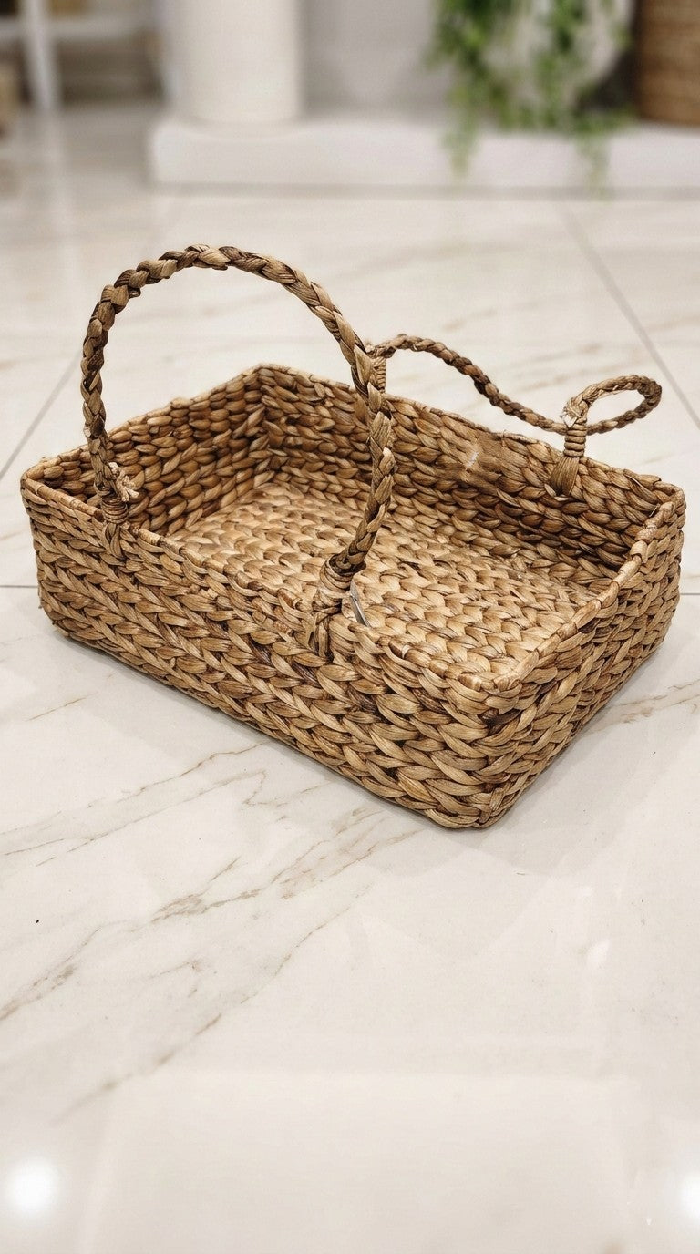 hand Woven water hyacinth basket with handles on a marble floor