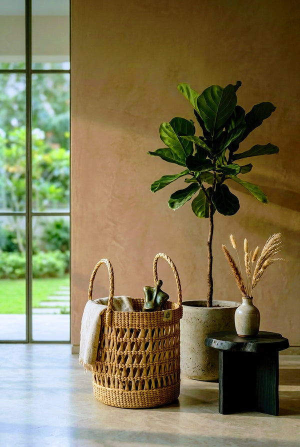 Indoor setting with a hand woven kauna grass big basket, potted plant, and decorative vase on a table