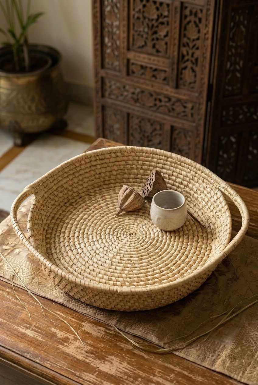 hand Woven grass basket with a small cup on a wooden surface, with a decorative wooden panel in the background.