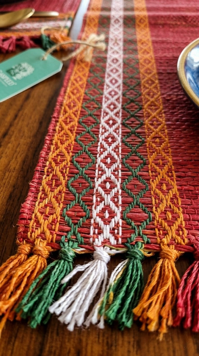 Colorful woven madurkathi grass mat  with tassels on a wooden surface. Placemat.