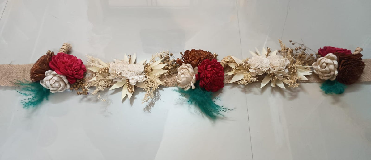 Handmade dry flower toran in red and ivory with teal accents on a jute base, 3 ft